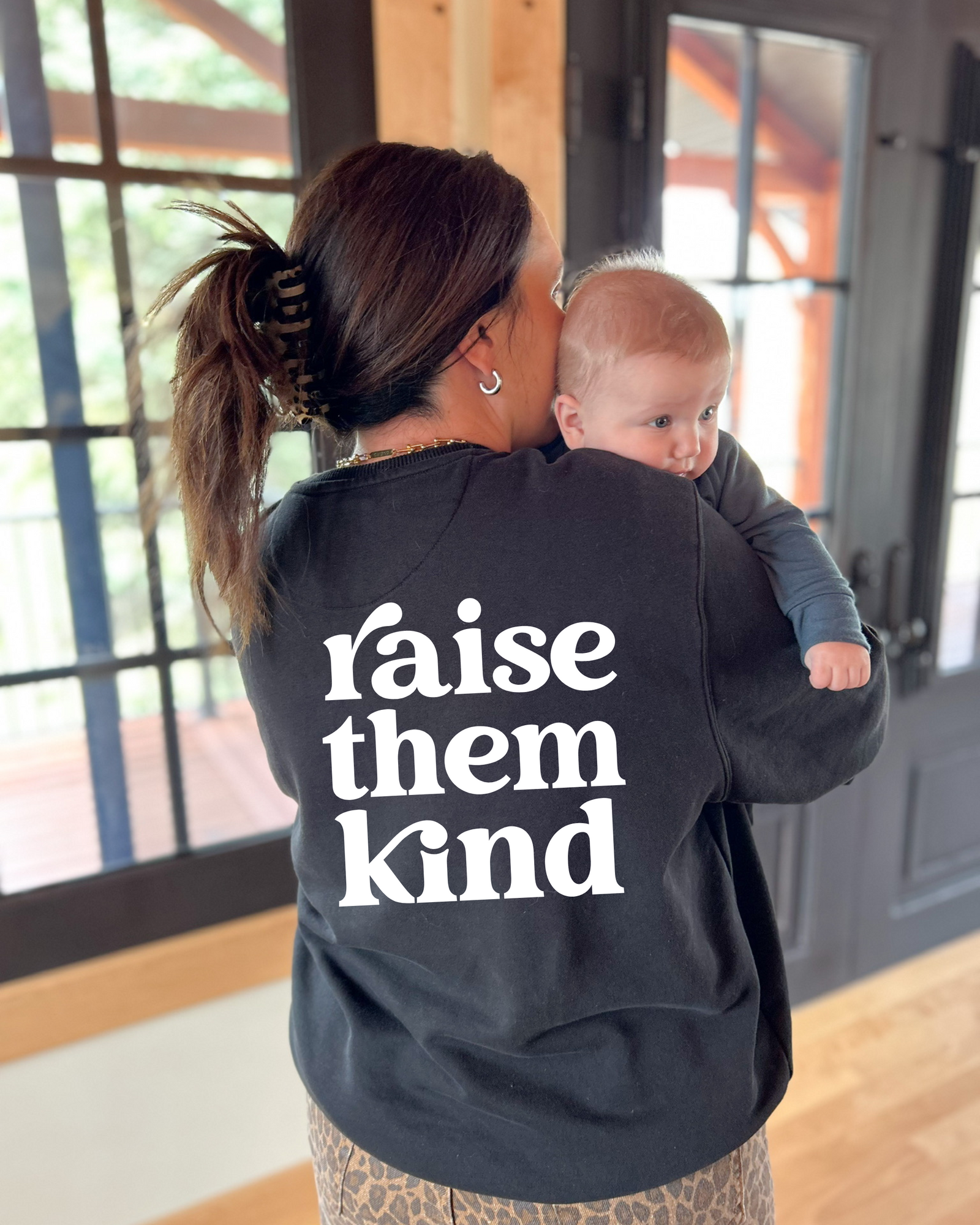 Burgundy Raise Them Kind walking with baby