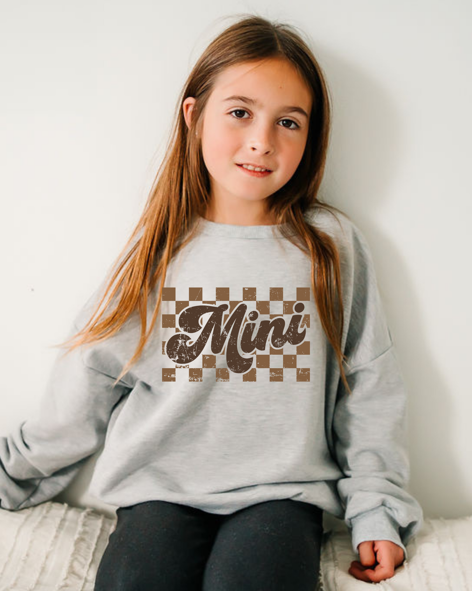 Mother and daughter wearing the Mini Check crewneck and black lounge sweater