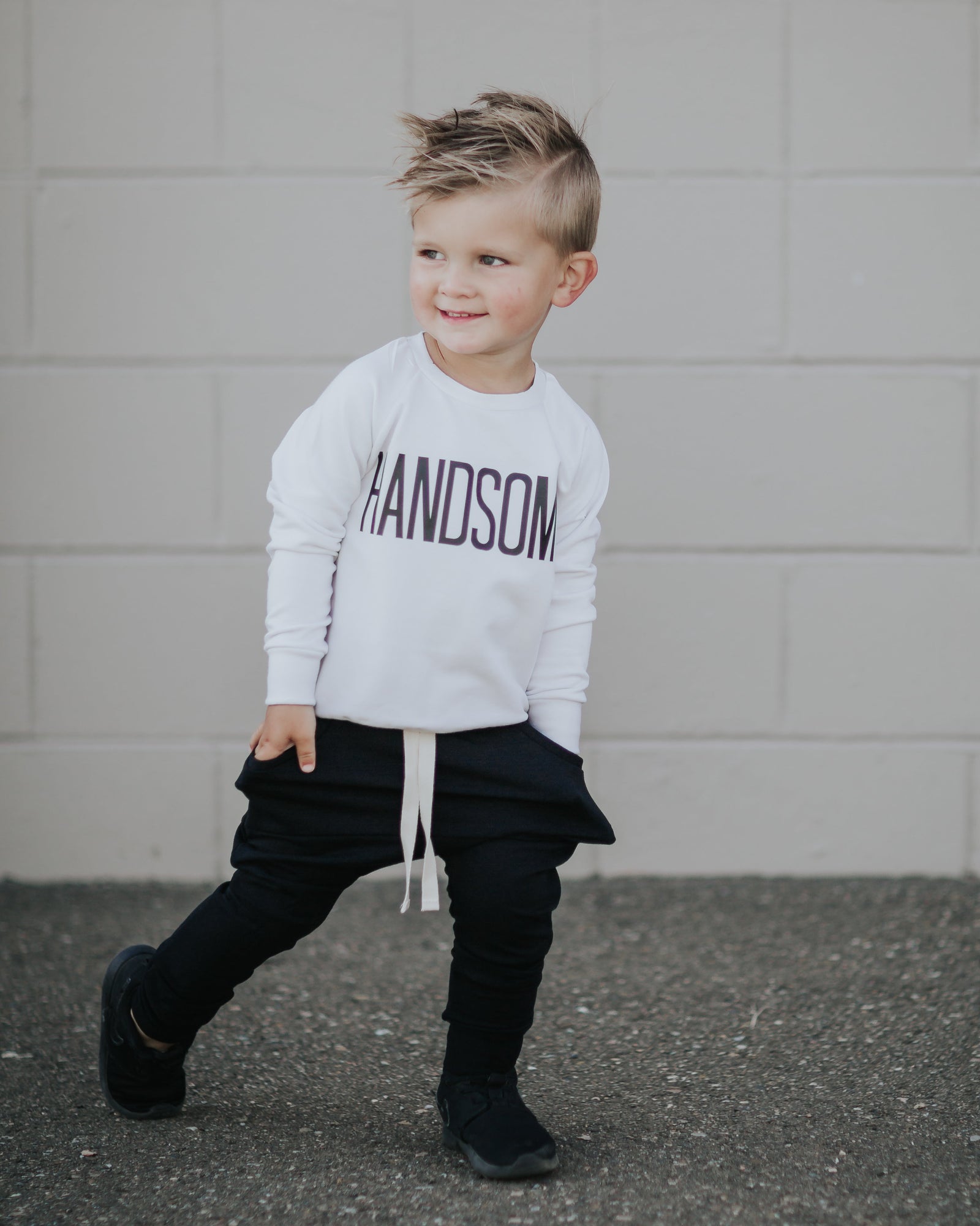 Two little boys in HANDSOME sweaters, beanies, and relaxed sweatpants