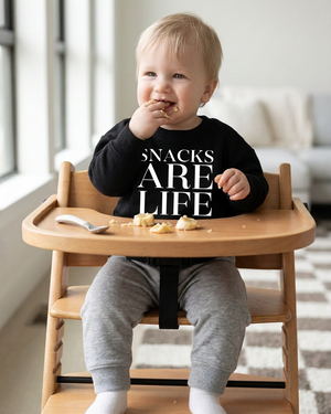 Baby with a larger SNACKS ARE LIFE print