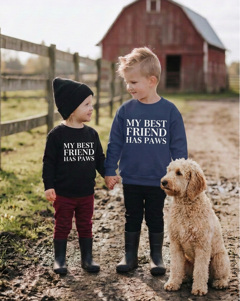 Both kids wearing matching white decals beside the goldendoodle