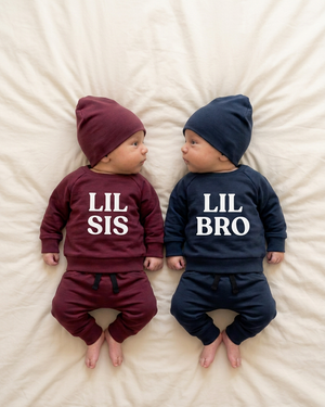 Burgundy baby with white LIL SIS and navy baby with white LIL BRO lettering