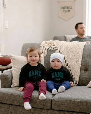 Game-day couch photo with the boy’s pants matched to the navy reference