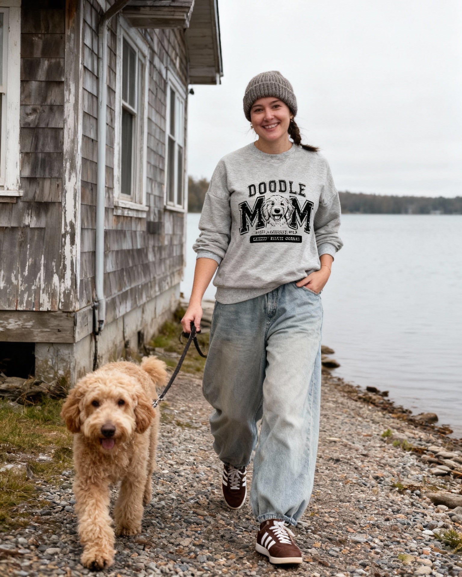 Burgundy Golden Mom crewneck with black print beside the cabin