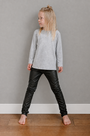 Girl against a darker grey wall with modern straight-edged trim and no outlet