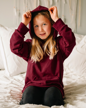 Girl wearing a rich burgundy hoodie