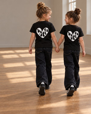 Girls walking in Besties tees with larger, lower back decals and expanded studio background