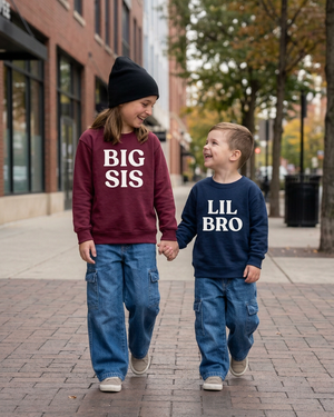 Kids wearing burgundy BIG SIS and navy LIL BRO crewneck sweaters