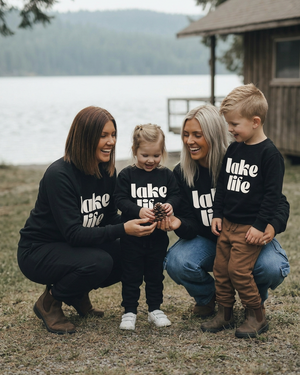 Playful family moment by the lakeshore