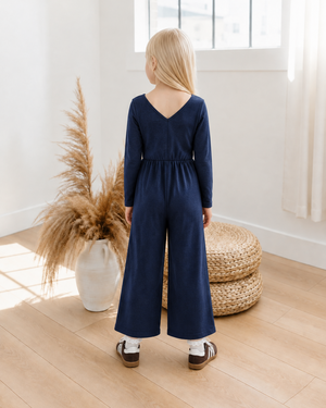Rear view of navy romper with a V-shaped back neckline