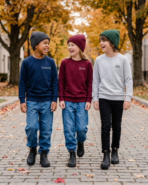 Tommy, Britt, and Jay wearing personalized name crewnecks on a fall street
