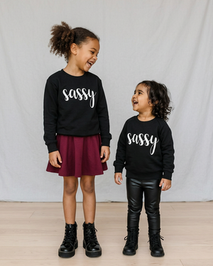 Two girls standing together in black sassy sweaters